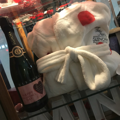 A plush white robe and a custom labeled bottle of Glenora Brut, decorated with Valentines items